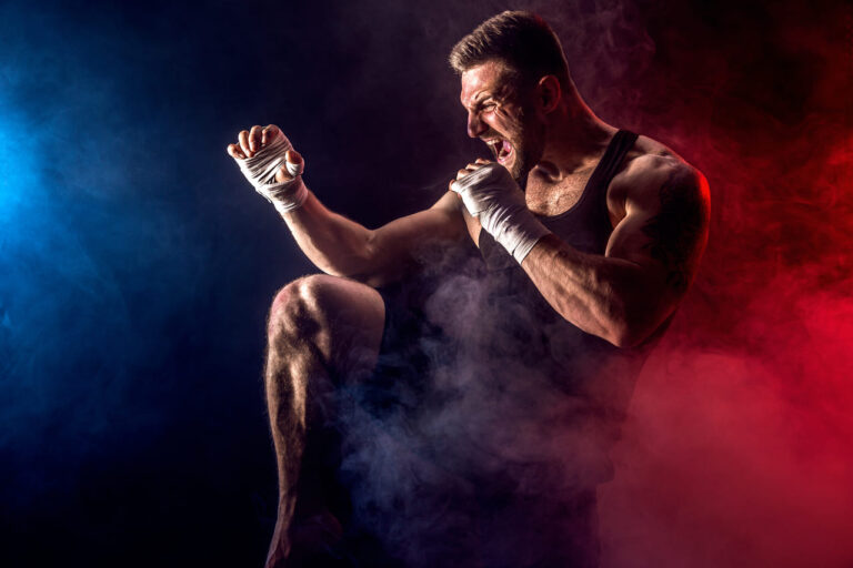 sportsman-muay-thai-boxer-fighting-on-black-wall-with-smoke (1)