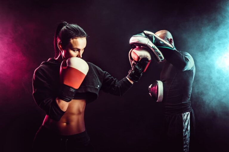 woman-exercising-with-trainer-at-boxing-and-self-defense-lesson